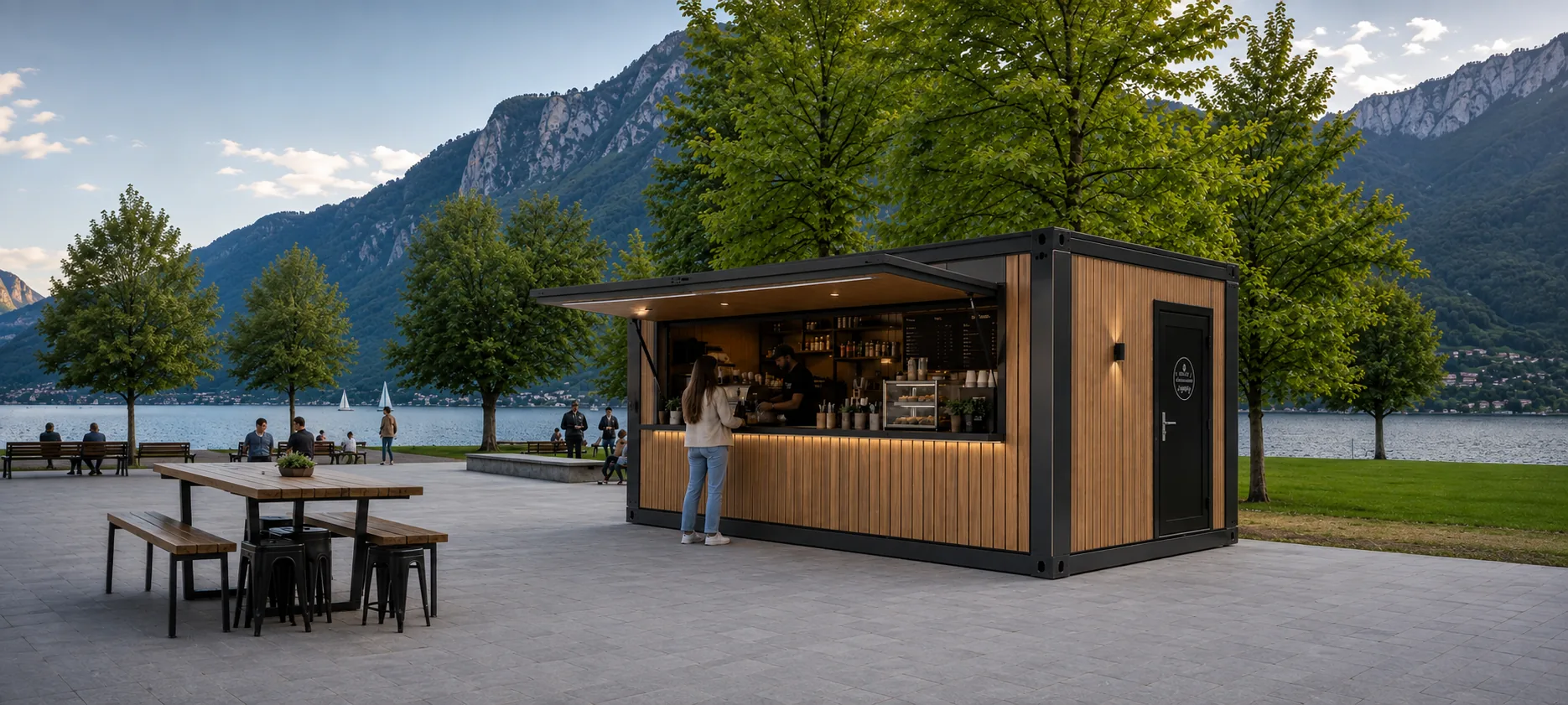 Verkaufsmodul mit hochgeklappter Fassadenklappe als Kaffeebar am See, davor Tische und Bänke