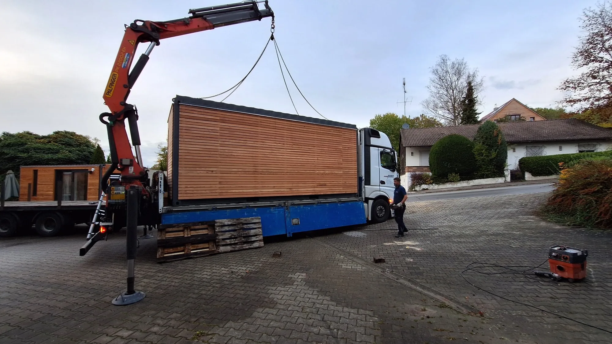 Gartenhaus mit Lärchenholzfassade auf dem Lkw vor der Aufstellung